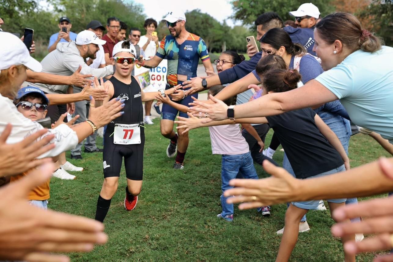 Well-wishers congratulate Nico Reyes for completing the Katy Triathlon on October 29th – the first child in the world with Down Syndrome to complete a triathlon in the sprint category at just 11 years of age.